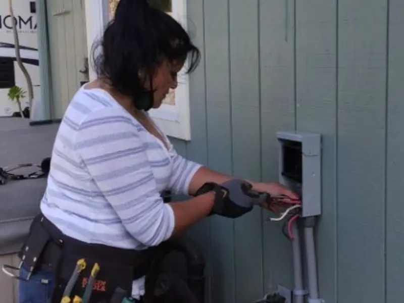 Licensed electrician wiring an exterior subpanel in Matawan